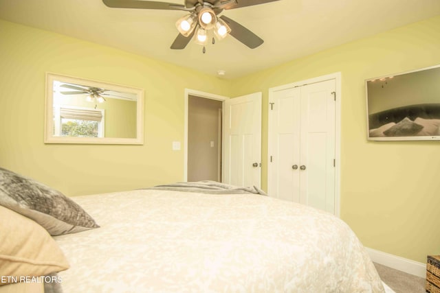 carpeted bedroom with a closet, a ceiling fan, and baseboards