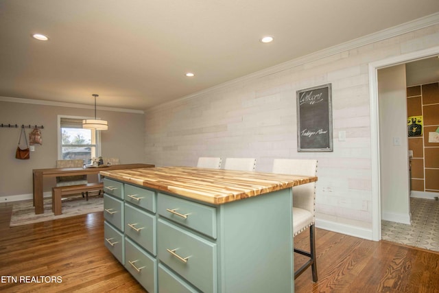 kitchen with ornamental molding, wood counters, dark wood finished floors, and green cabinetry