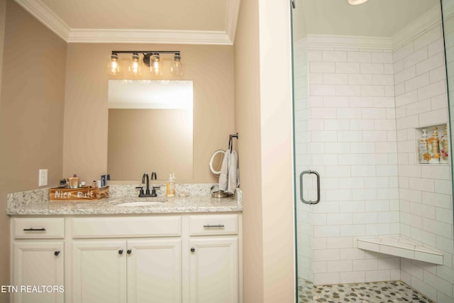 bathroom with ornamental molding, a stall shower, and vanity