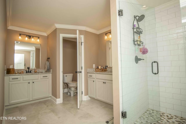 bathroom with toilet, a shower stall, a sink, and crown molding