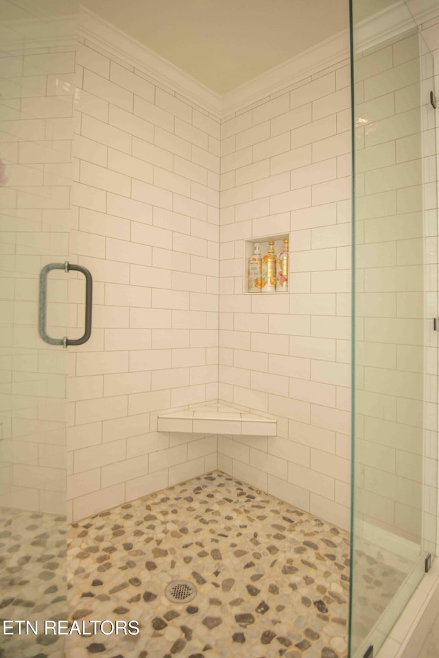 full bath featuring a stall shower and crown molding