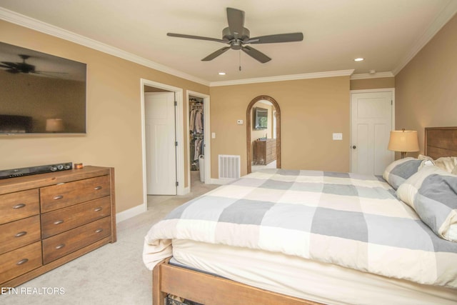 bedroom with arched walkways, light carpet, visible vents, baseboards, and ornamental molding