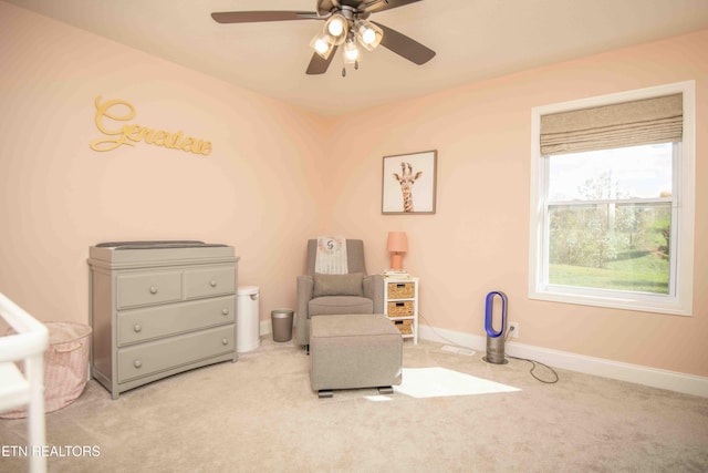 sitting room with a ceiling fan, carpet flooring, and baseboards