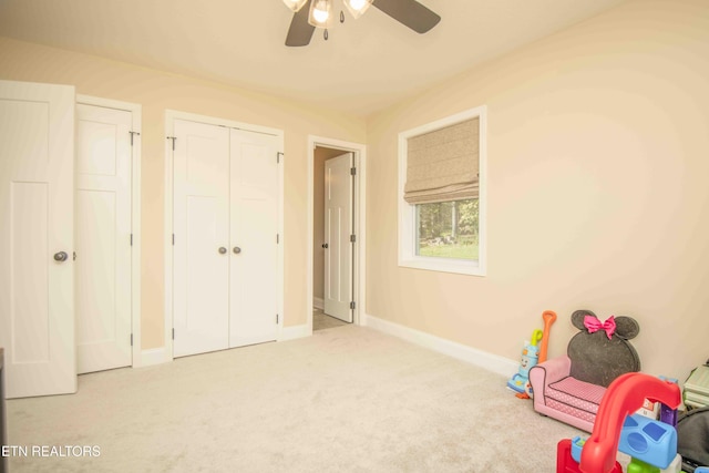 rec room featuring carpet, baseboards, and a ceiling fan