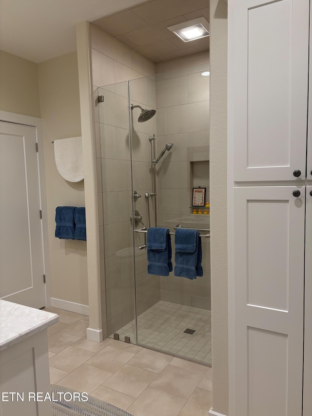 193 Holly Tree Dr, Crossville, TN 38555 - bathroom featuring a stall shower, tile patterned floors, baseboards, and vanity