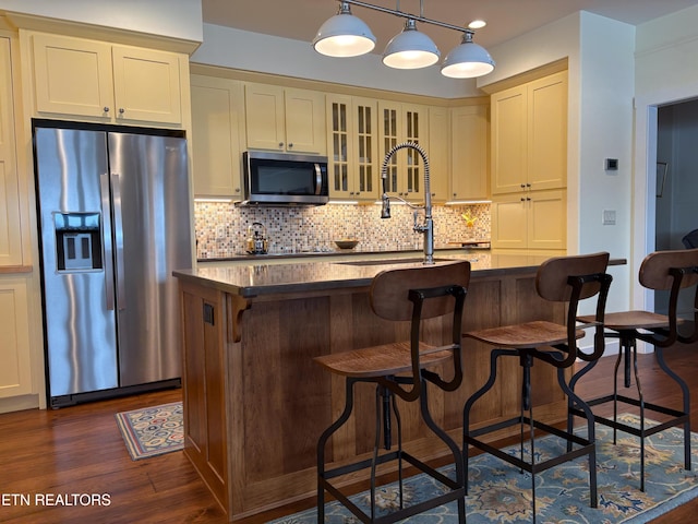 193 Holly Tree Dr, Crossville, TN 38555 - kitchen with dark countertops, backsplash, stainless steel appliances, and dark wood-style flooring