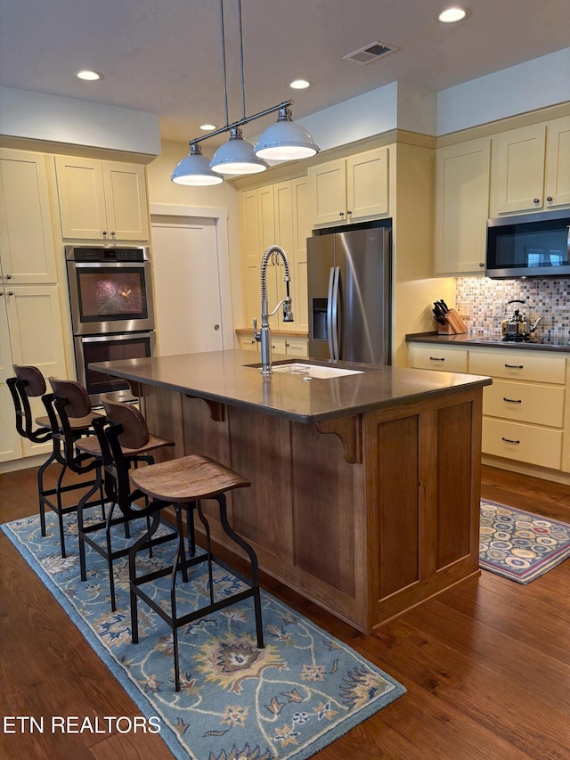 193 Holly Tree Dr, Crossville, TN 38555 - kitchen featuring appliances with stainless steel finishes, dark wood-type flooring, dark countertops, and visible vents