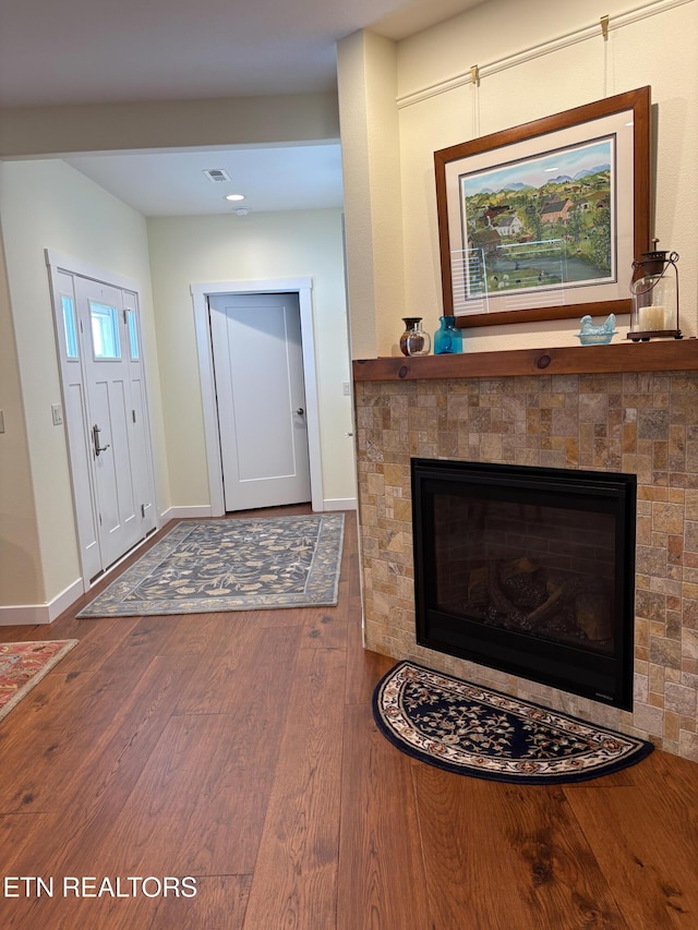 193 Holly Tree Dr, Crossville, TN 38555 - foyer entrance featuring visible vents, a fireplace, baseboards, and wood finished floors