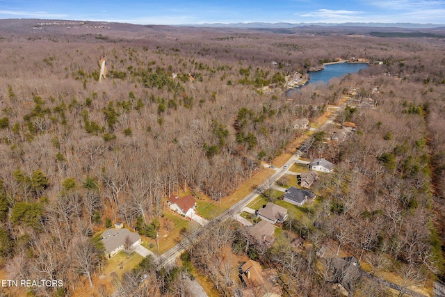 aerial view featuring a water view and a view of trees