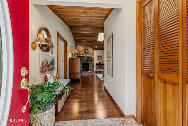 hallway featuring hardwood / wood-style floors, wooden ceiling, and baseboards