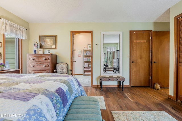 bedroom featuring baseboards and wood finished floors