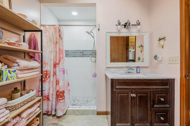 bathroom featuring a stall shower and vanity