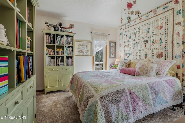 bedroom with a textured ceiling and carpet