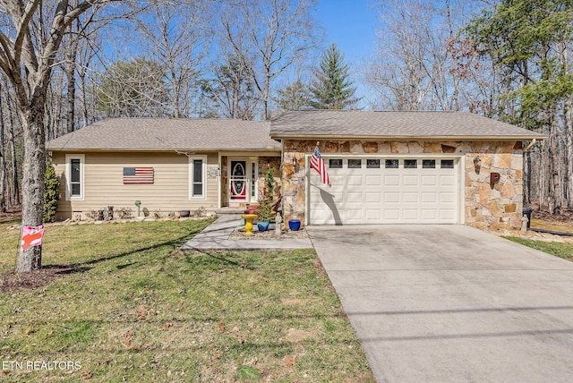 ranch-style home with a front yard, stone siding, an attached garage, and concrete driveway