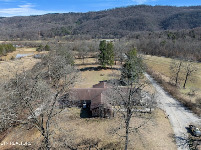 drone / aerial view with a rural view, a wooded view, and a mountain view