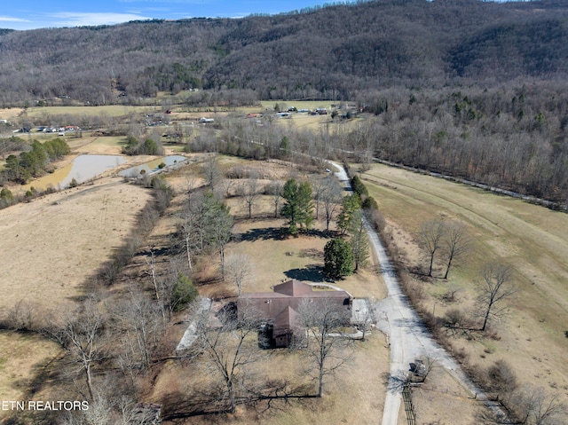 aerial view featuring a rural view and a wooded view