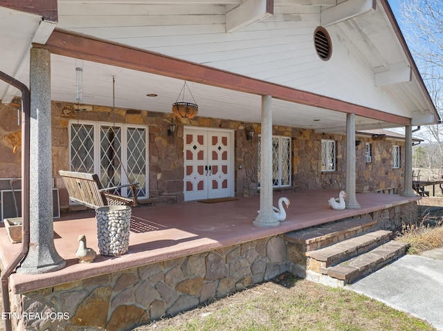 view of patio / terrace featuring a porch and a garage