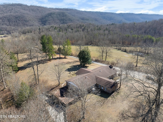 birds eye view of property with a rural view, a wooded view, and a mountain view