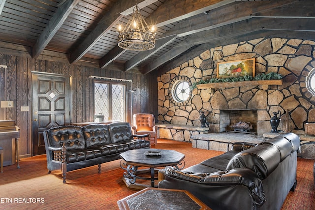 living room featuring lofted ceiling with beams, wood walls, a fireplace, and an inviting chandelier