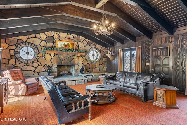 living area featuring lofted ceiling with beams, an inviting chandelier, wood walls, and a stone fireplace