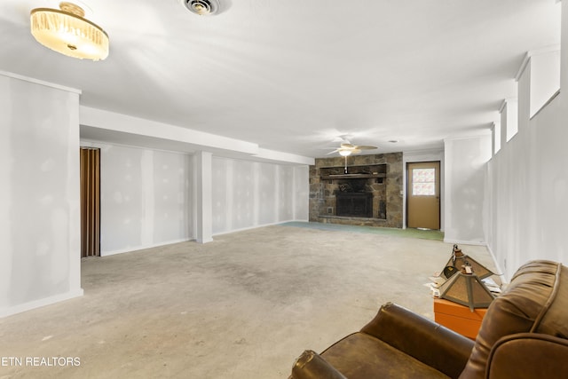 living room featuring a ceiling fan, visible vents, and a fireplace