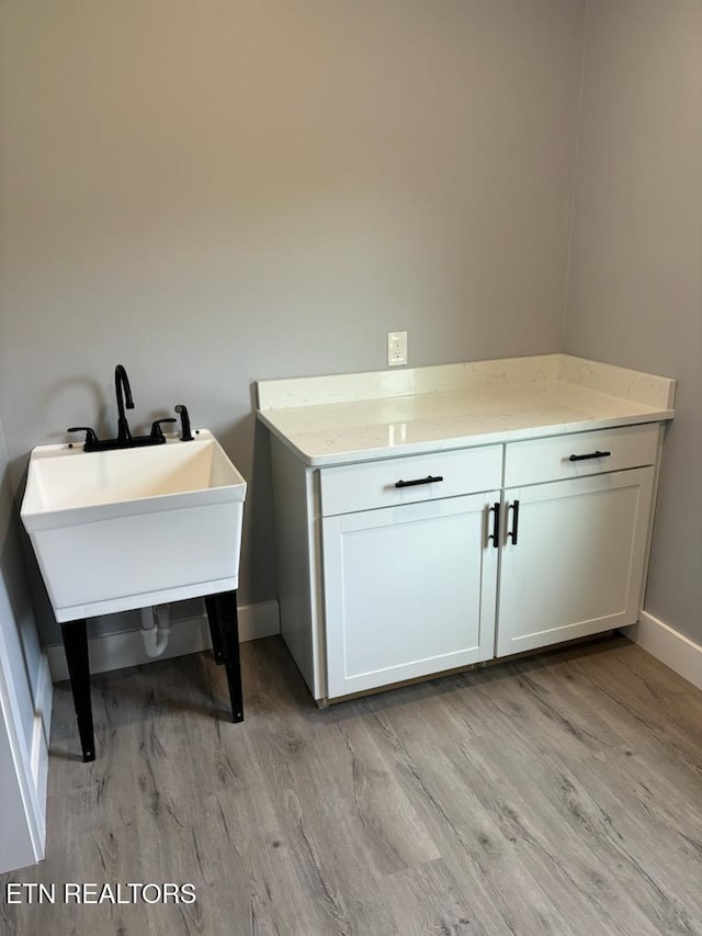 bathroom featuring wood finished floors and baseboards