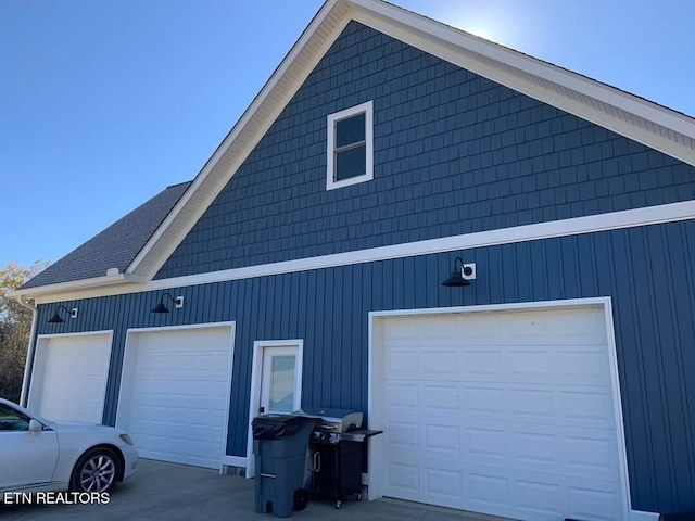 view of property exterior with a garage and a shingled roof