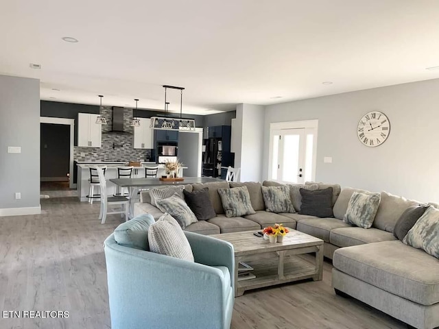 living area with light wood finished floors and baseboards