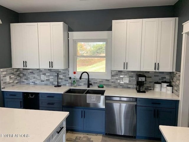 kitchen featuring white cabinetry, dishwasher, and a sink