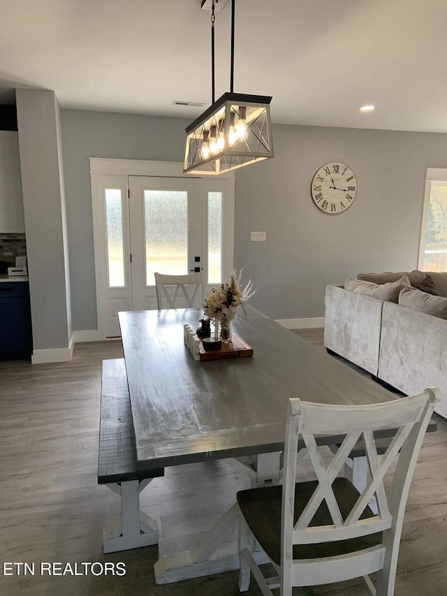 dining room with recessed lighting, light wood-style flooring, and baseboards