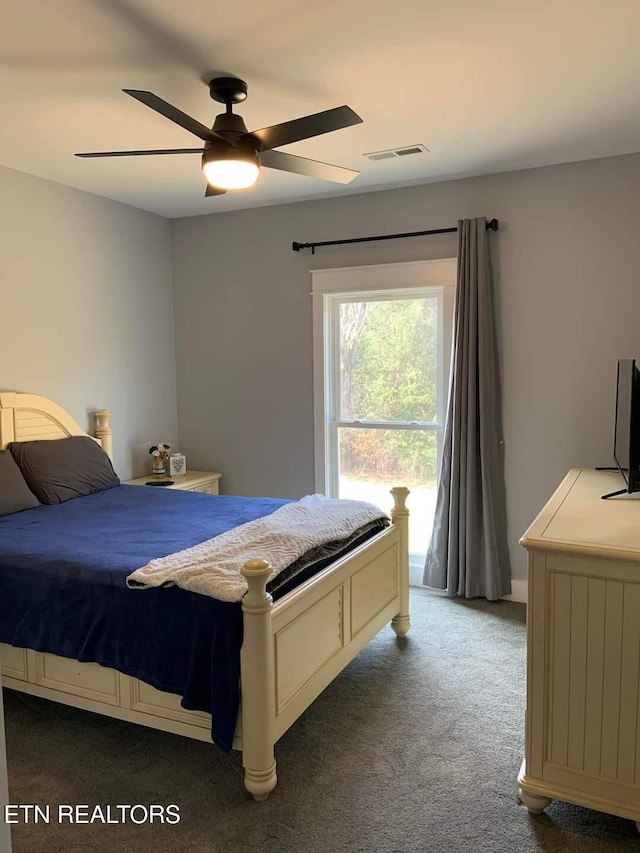 bedroom with carpet floors, ceiling fan, and visible vents