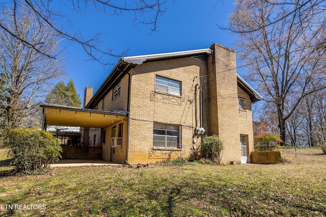 view of home's exterior featuring a chimney, cooling unit, a lawn, and brick siding