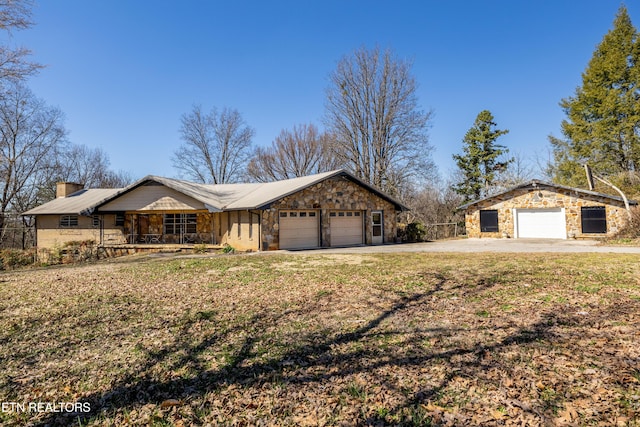 view of front facade with covered porch, stone siding, concrete driveway, and an attached garage