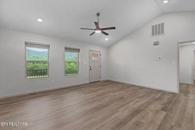 interior space with baseboards, visible vents, and wood finished floors