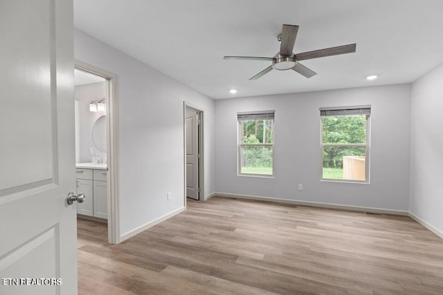 unfurnished bedroom with light wood-style flooring, baseboards, connected bathroom, and recessed lighting