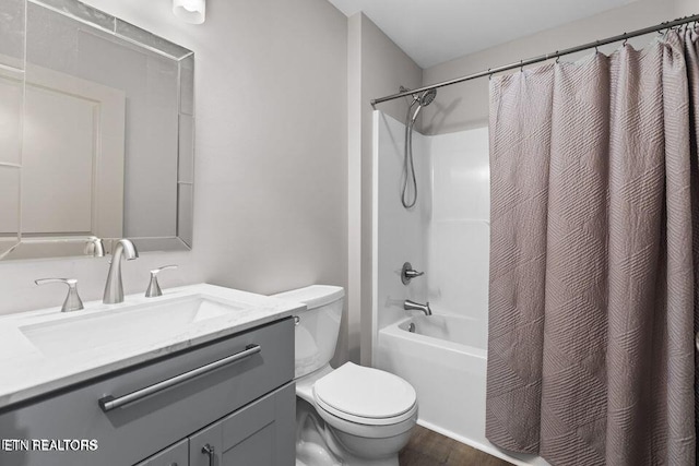 full bathroom featuring wood finished floors, vanity, toilet, and shower / tub combo with curtain