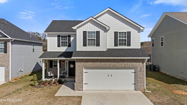 traditional-style home featuring a garage, board and batten siding, concrete driveway, central AC, and brick siding