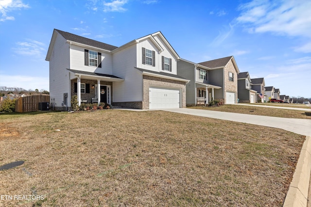 traditional-style house featuring central air condition unit, concrete driveway, an attached garage, fence, and a front lawn