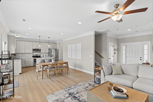 living area with recessed lighting, light wood-style flooring, ornamental molding, baseboards, and stairs