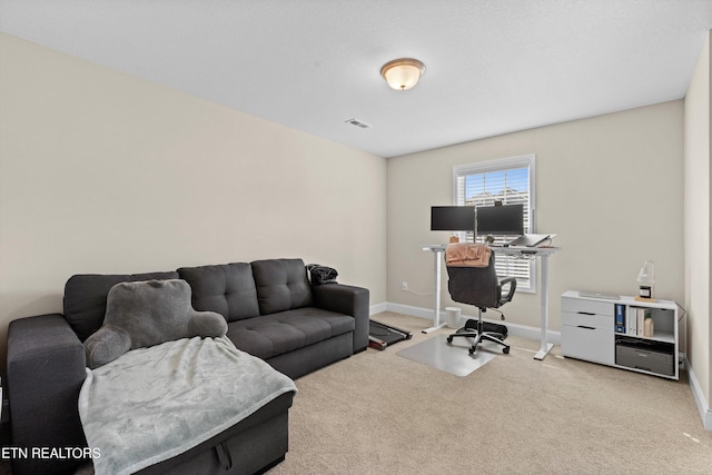 office with carpet flooring, visible vents, and baseboards