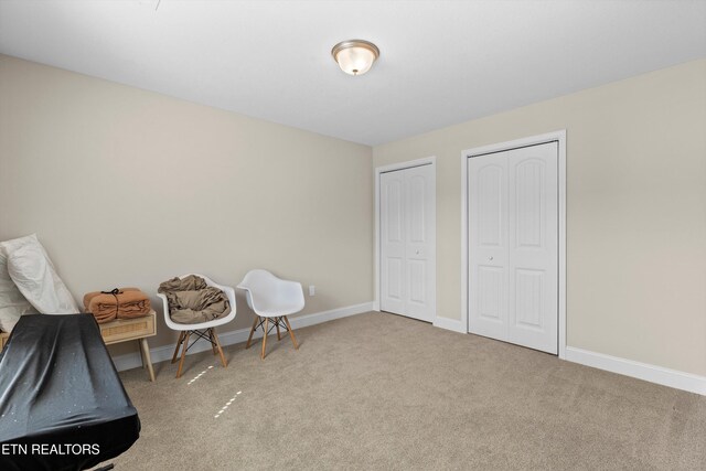 interior space with baseboards and carpet flooring