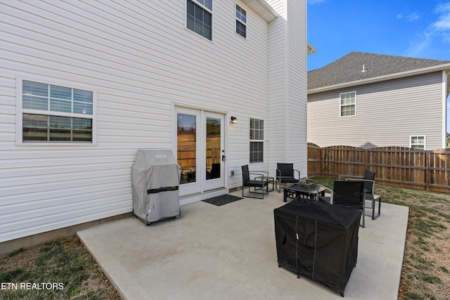 view of patio with an outdoor fire pit, fence, and grilling area