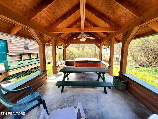 view of patio with a hot tub, a ceiling fan, and a gazebo