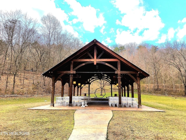 view of community featuring a lawn, a gazebo, and a patio