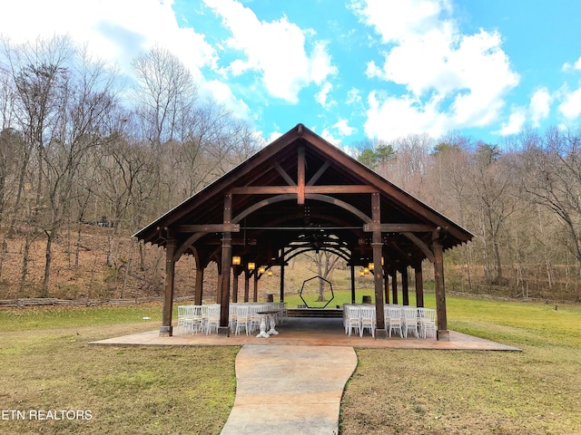 view of community featuring a yard, a patio area, and a gazebo