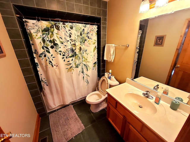 bathroom with tile patterned flooring, vanity, and toilet