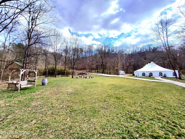 view of yard with a view of trees