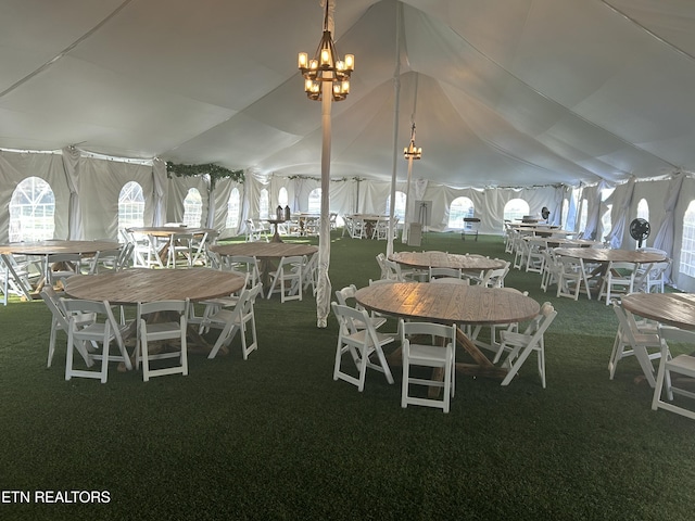 unfurnished dining area featuring carpet floors, vaulted ceiling, and an inviting chandelier