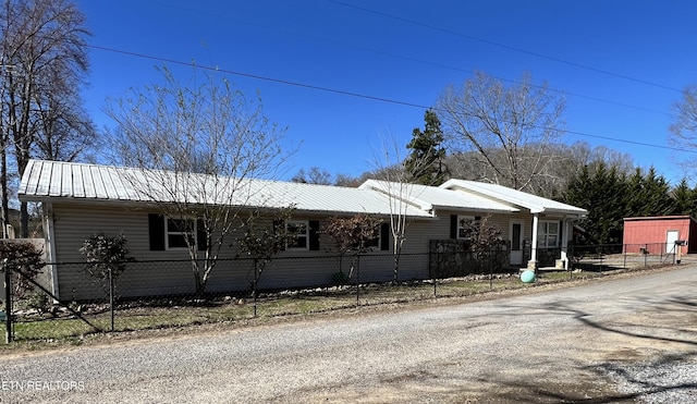 view of front of house featuring a fenced front yard and metal roof