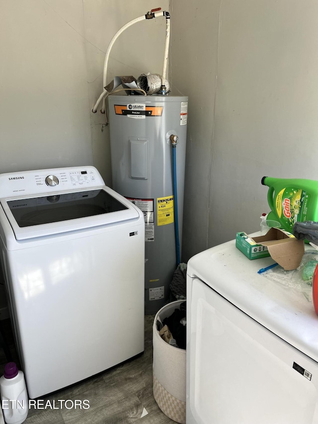 washroom featuring wood finished floors, washer / clothes dryer, electric water heater, and laundry area